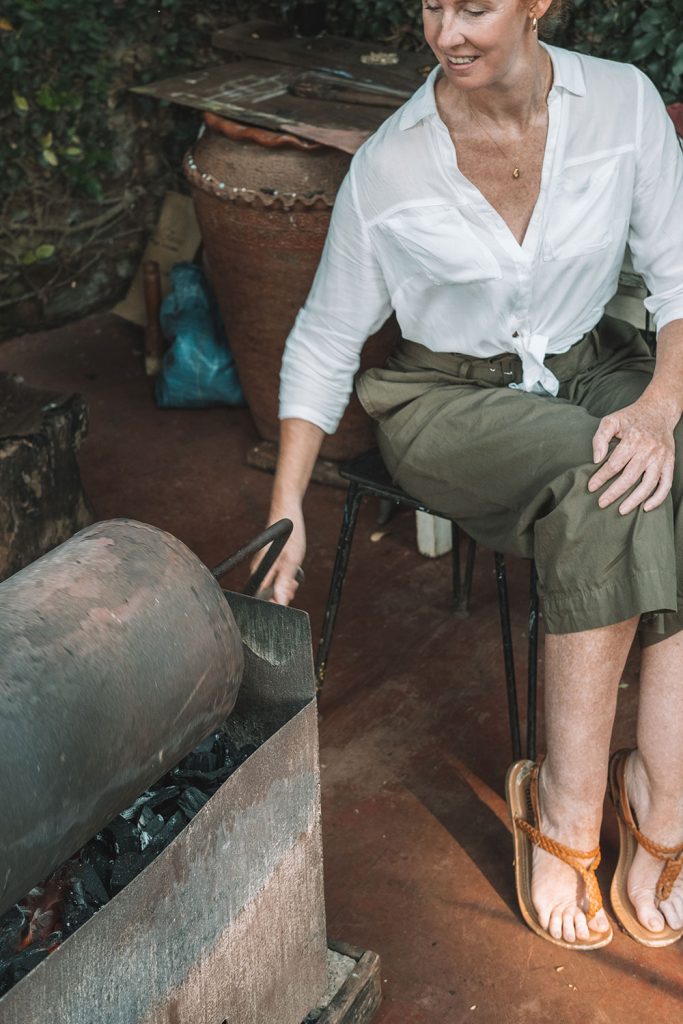 Woman roasting Arabica coffee is earning her keep on the farm